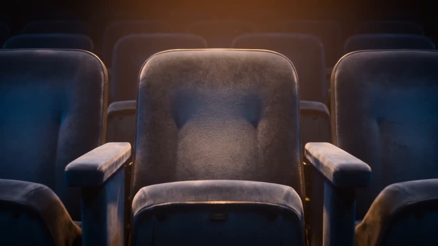 A single theatre seat in warm light